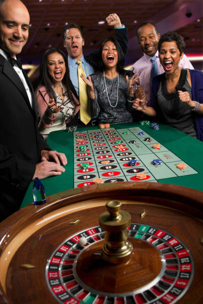 Live dealer revealing outcome card in baccarat game